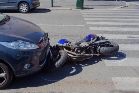 motorcycle crash front of car