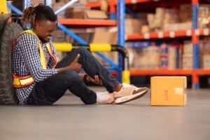 A warehouse employee suffered a leg accident at work. Lawyers can advise on a potential workers compensation case