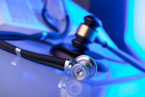 A gavel beside a stethoscope in a courtroom represents a medical malpractice case in Oklahoma City.