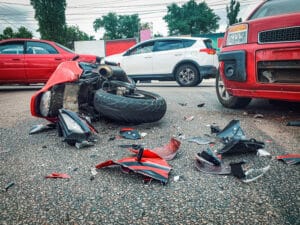 Multi-vehicle accident involving a motorcycle, a truck, and two cars, making it unclear who is liable