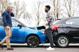 Two drivers speaking with each other after being in a car accident