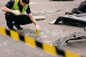 Policeman going over car accident scene